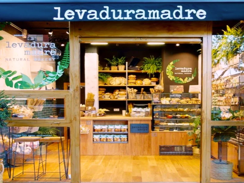Fachada de la panadería artesanal Levadura Madre Natural Bakery con variedad de panes artesanales y productos naturales en exhibición.