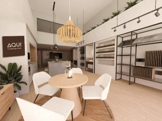 Interior de una tienda de Aquí tu Reforma México con diseño moderno, iluminación cálida y mobiliario de estilo nórdico, representando el concepto phygital de la franquicia de reformas.